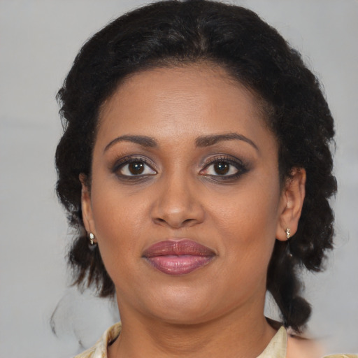 Joyful black young-adult female with medium  brown hair and brown eyes