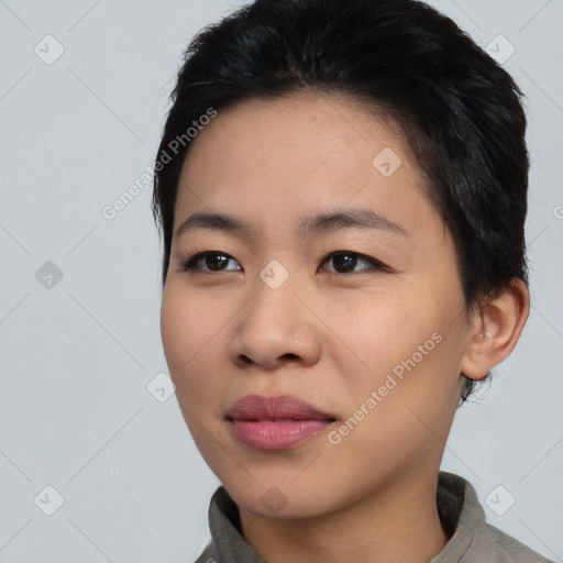 Joyful asian young-adult female with short  black hair and brown eyes