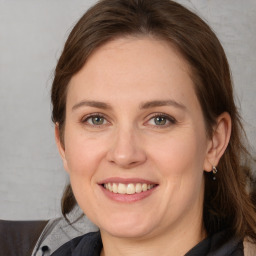 Joyful white adult female with medium  brown hair and grey eyes