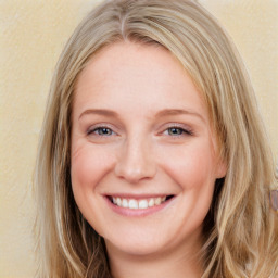 Joyful white young-adult female with long  brown hair and blue eyes