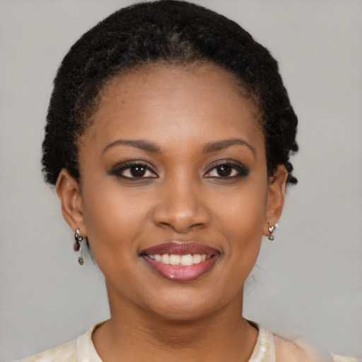 Joyful black young-adult female with short  brown hair and brown eyes