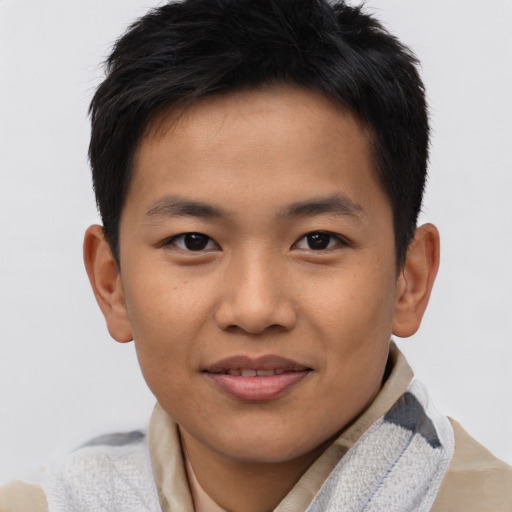 Joyful asian young-adult male with short  brown hair and brown eyes