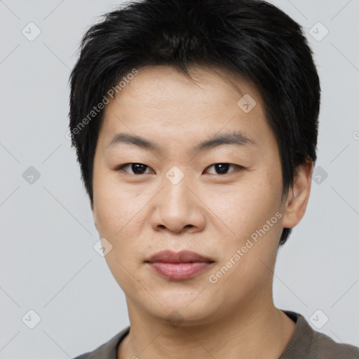 Joyful asian young-adult male with short  brown hair and brown eyes