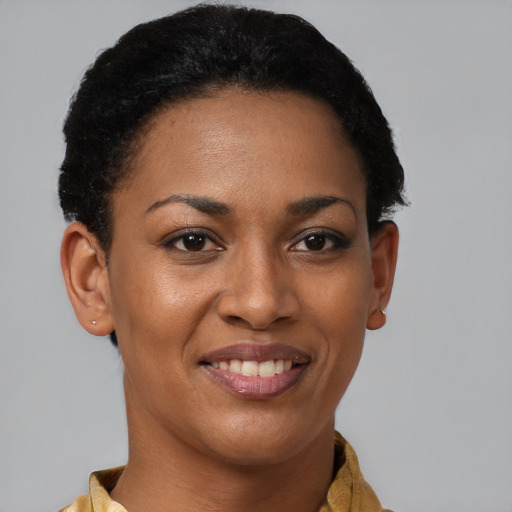 Joyful black young-adult female with short  brown hair and brown eyes