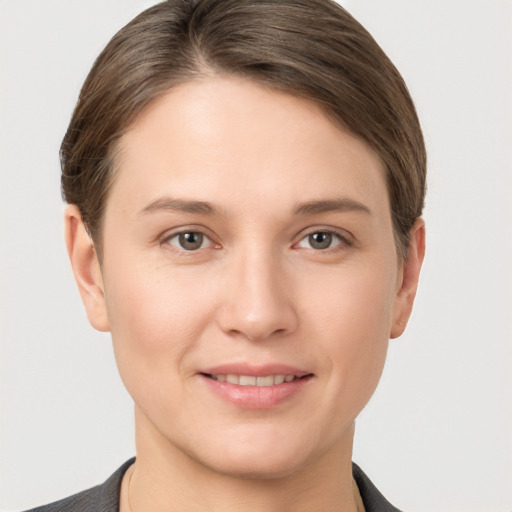 Joyful white young-adult female with short  brown hair and grey eyes