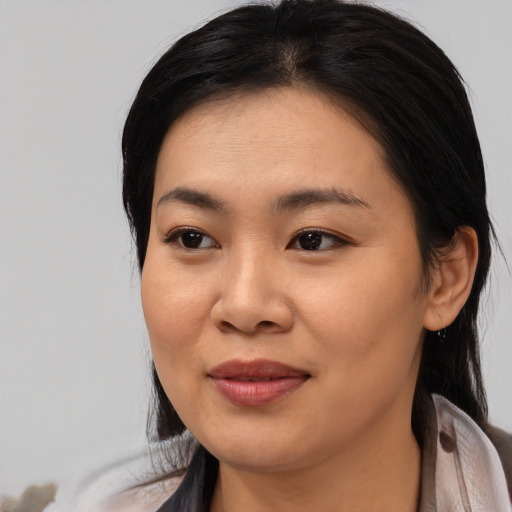 Joyful asian young-adult female with medium  black hair and brown eyes