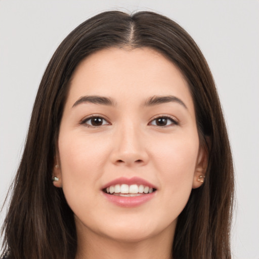 Joyful white young-adult female with long  brown hair and brown eyes