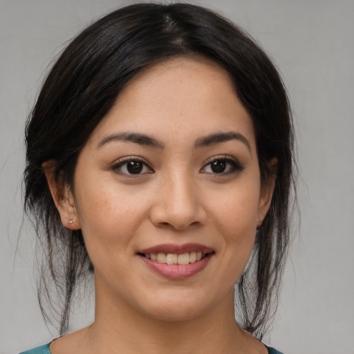 Joyful asian young-adult female with medium  brown hair and brown eyes