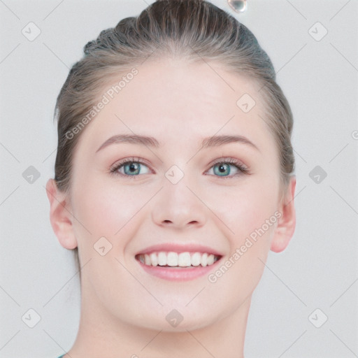 Joyful white young-adult female with short  brown hair and blue eyes