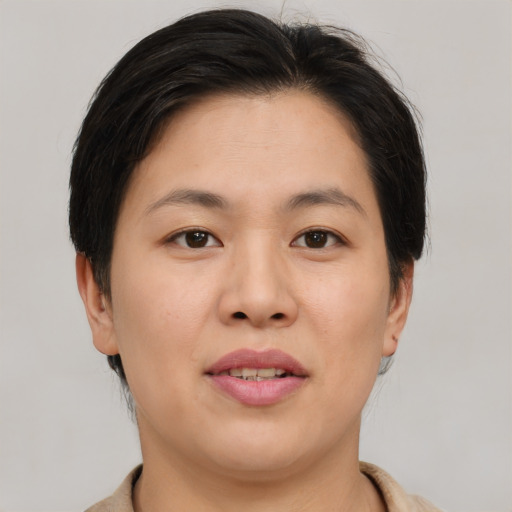 Joyful asian young-adult female with short  brown hair and brown eyes