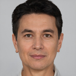 Joyful white adult male with short  black hair and brown eyes