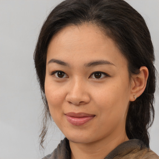 Joyful white young-adult female with medium  brown hair and brown eyes