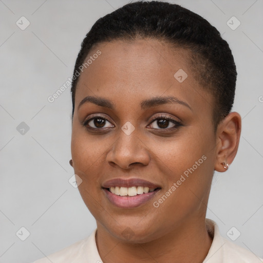 Joyful black young-adult female with short  brown hair and brown eyes