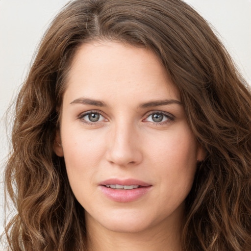 Joyful white young-adult female with long  brown hair and green eyes