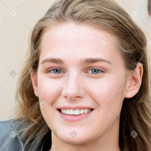 Joyful white young-adult female with long  brown hair and blue eyes