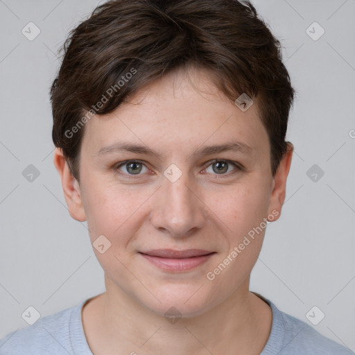 Joyful white young-adult female with short  brown hair and grey eyes