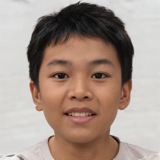 Joyful asian child male with short  brown hair and brown eyes