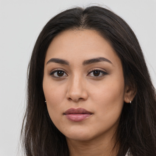 Neutral latino young-adult female with long  brown hair and brown eyes