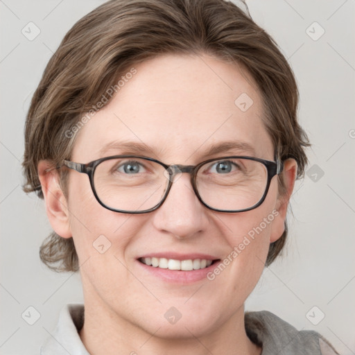 Joyful white adult female with medium  brown hair and blue eyes