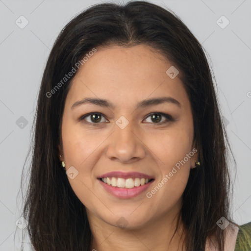 Joyful latino young-adult female with long  brown hair and brown eyes