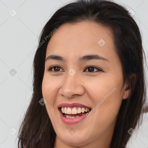 Joyful asian young-adult female with long  brown hair and brown eyes