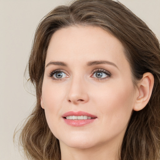 Joyful white young-adult female with long  brown hair and green eyes