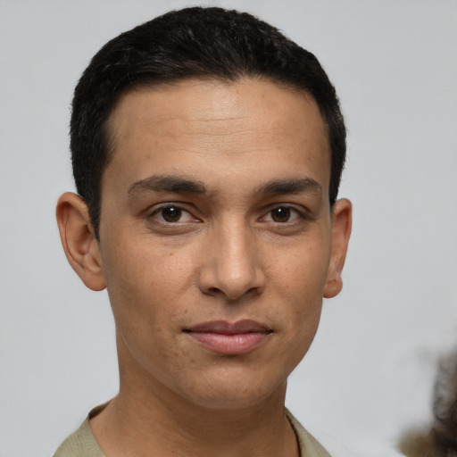 Joyful latino young-adult male with short  black hair and brown eyes