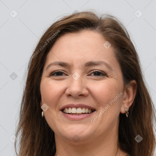 Joyful white adult female with long  brown hair and brown eyes