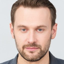 Joyful white young-adult male with short  brown hair and grey eyes