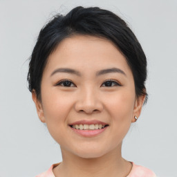 Joyful asian young-adult female with short  brown hair and brown eyes