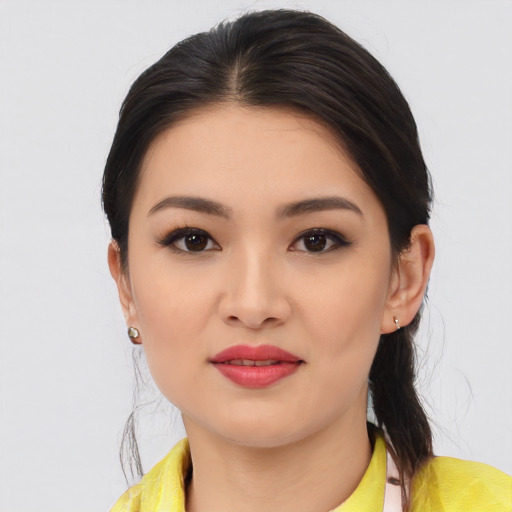Joyful asian young-adult female with medium  black hair and brown eyes