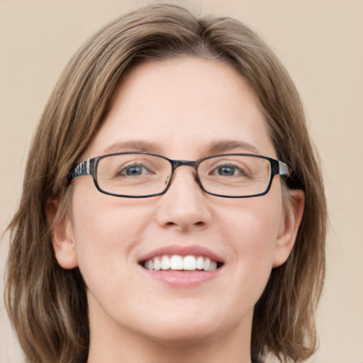 Joyful white adult female with medium  brown hair and green eyes