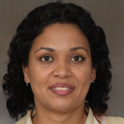 Joyful black adult female with medium  brown hair and brown eyes