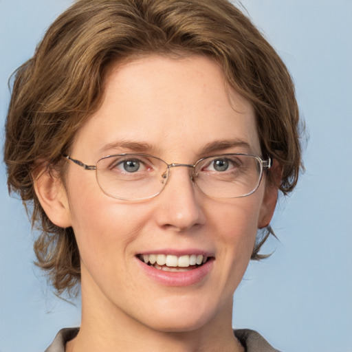 Joyful white adult female with medium  brown hair and grey eyes