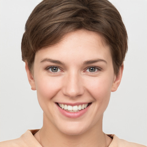 Joyful white young-adult female with short  brown hair and grey eyes