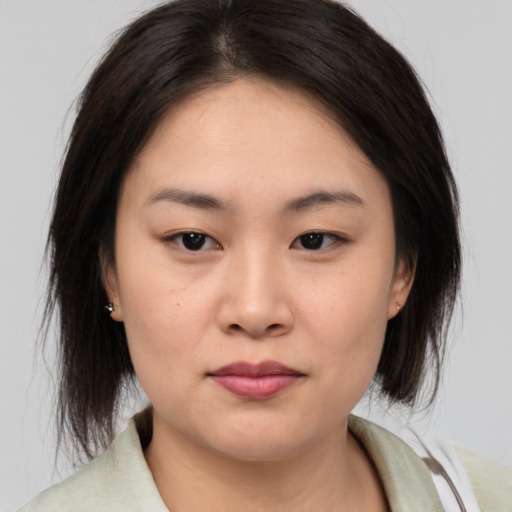 Neutral asian young-adult female with medium  brown hair and brown eyes
