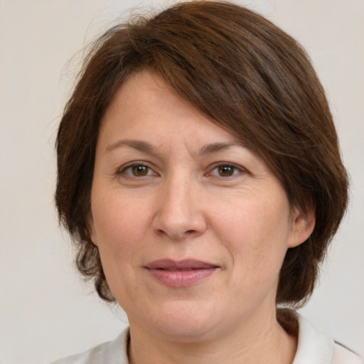 Joyful white adult female with medium  brown hair and brown eyes