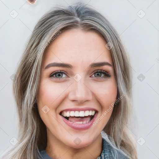 Joyful white young-adult female with long  brown hair and blue eyes