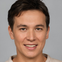 Joyful white young-adult male with short  brown hair and brown eyes