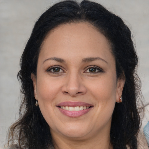 Joyful white adult female with long  brown hair and brown eyes