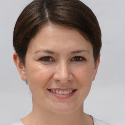 Joyful white young-adult female with short  brown hair and brown eyes