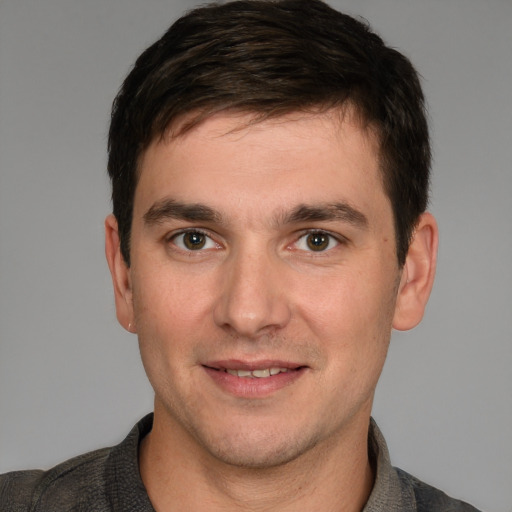 Joyful white young-adult male with short  brown hair and brown eyes