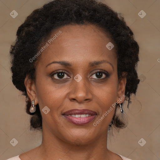 Joyful black adult female with medium  brown hair and brown eyes