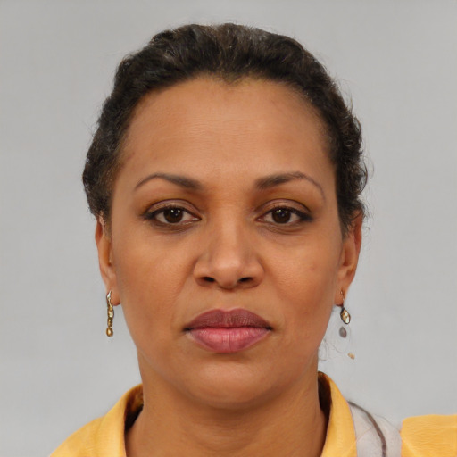 Joyful black adult female with short  brown hair and brown eyes
