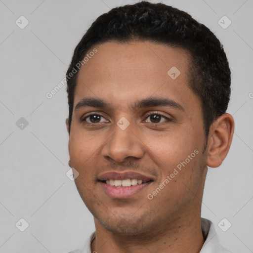 Joyful latino young-adult male with short  black hair and brown eyes