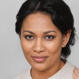 Joyful black adult female with short  brown hair and brown eyes