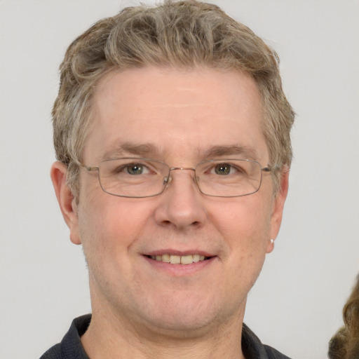 Joyful white middle-aged male with short  brown hair and grey eyes