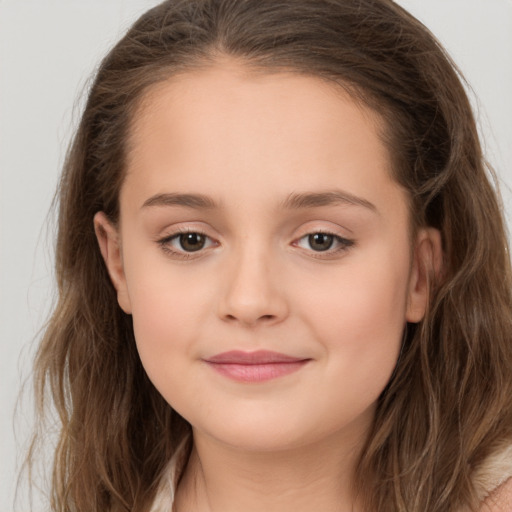 Joyful white child female with long  brown hair and brown eyes