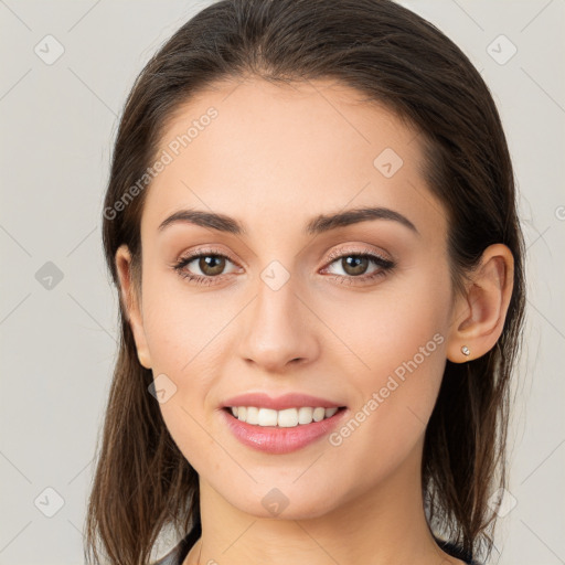 Joyful white young-adult female with long  brown hair and brown eyes