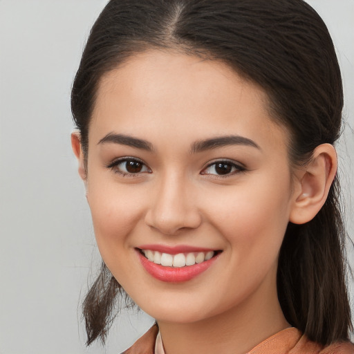 Joyful white young-adult female with long  brown hair and brown eyes